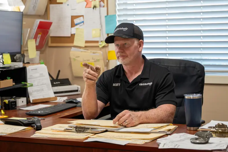 Scott at his desk reviewing a repair estimate at G&G AutoBody