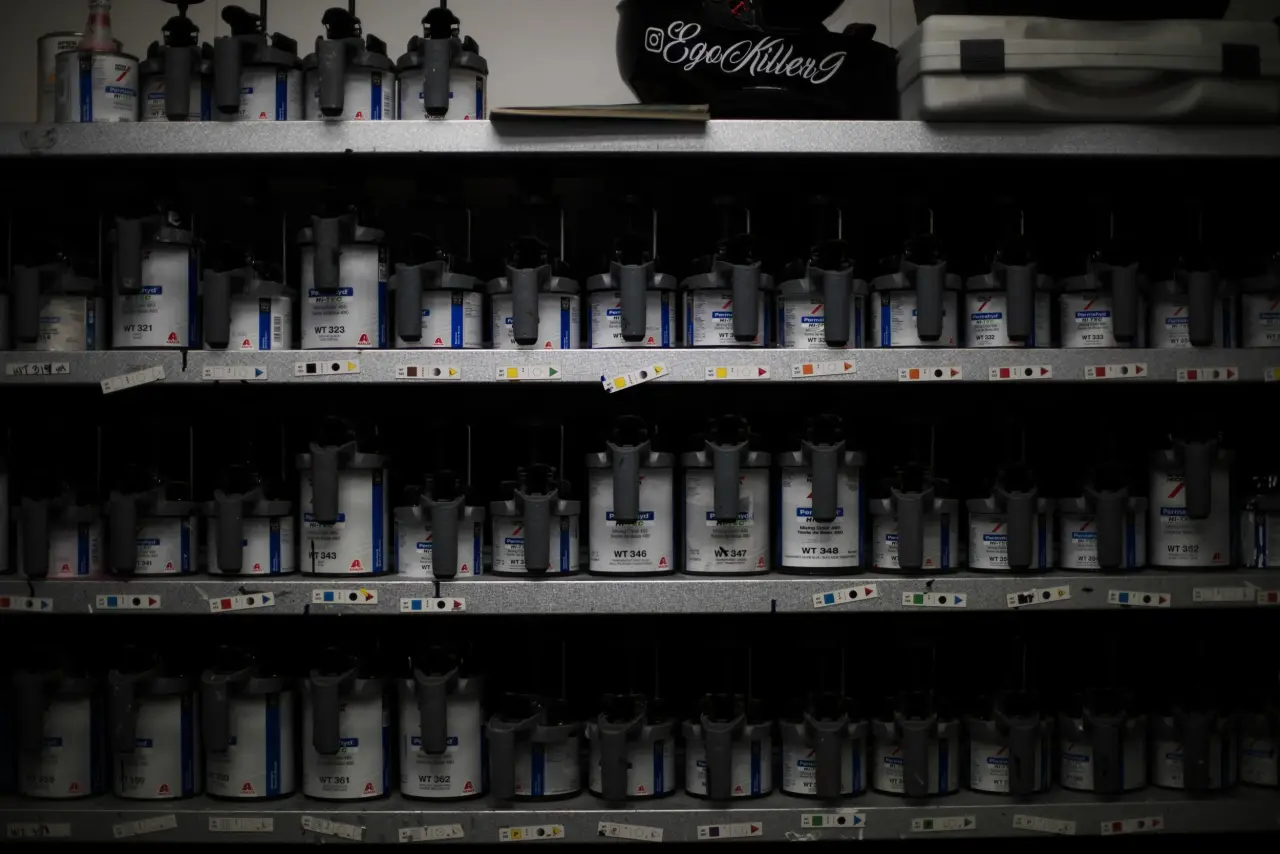 Shelves of paint and materials inside the G&G AutoBody shop